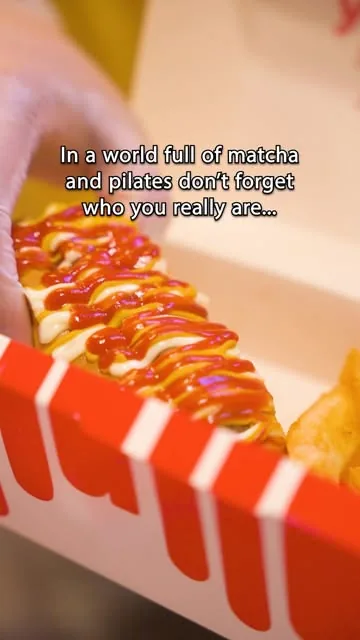 Close up of a stuffed hot dog with sauces